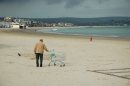 Seaside street photography - touching a trolley on Weymouth beach