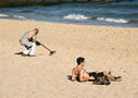 Metal detector and sunbather, Bournemouth