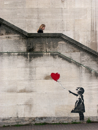 Banksy grafitti and woman, London