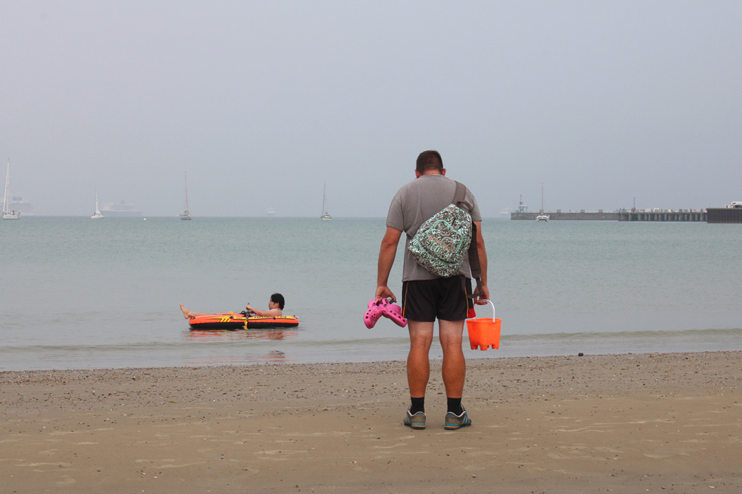 Photo 3, boy in dinghy and man with bucket in Weymouth