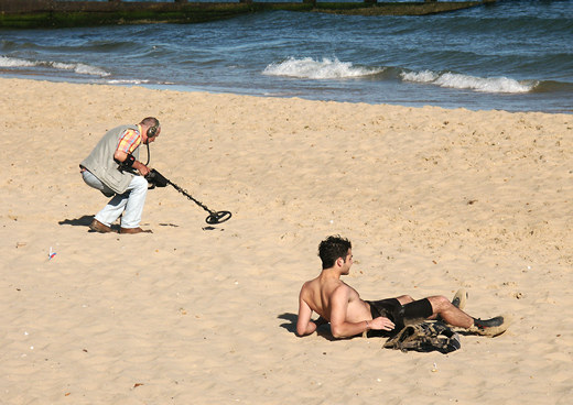 Metal detector and sunbather, Bournemouth